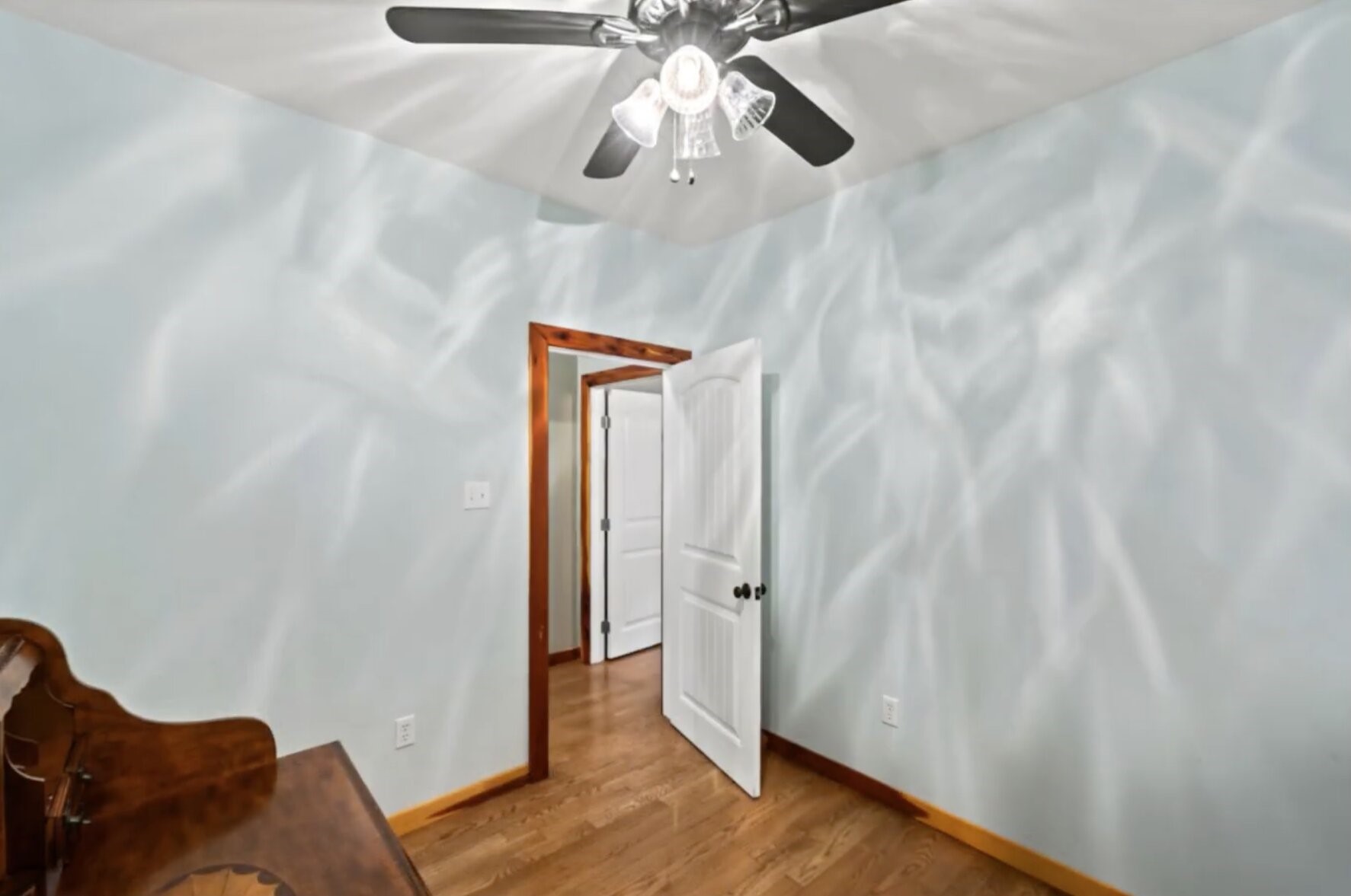 30338 Riley Road Waller, TX 77484 - Photo 29 of 46 a view of a hallway with wooden floor and a chandelier fan