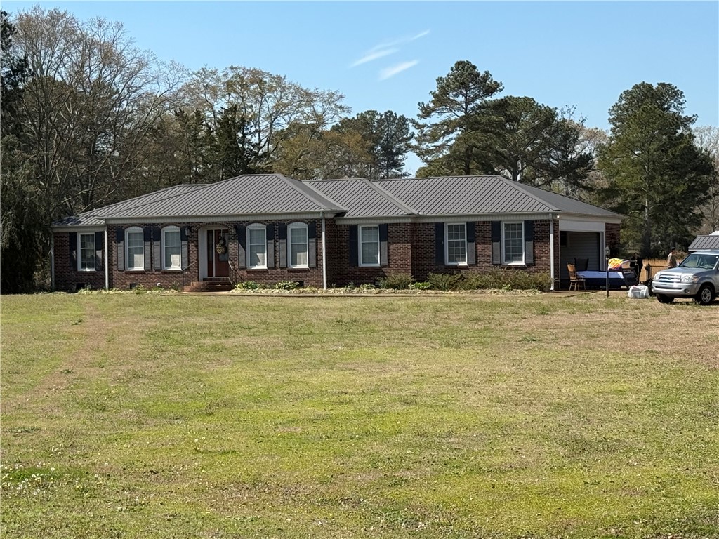121 Nautical Way Anderson, SC 29625 - Photo 2 of 37 A classic brick exterior with a durable metal roof offers lasting curb appeal.