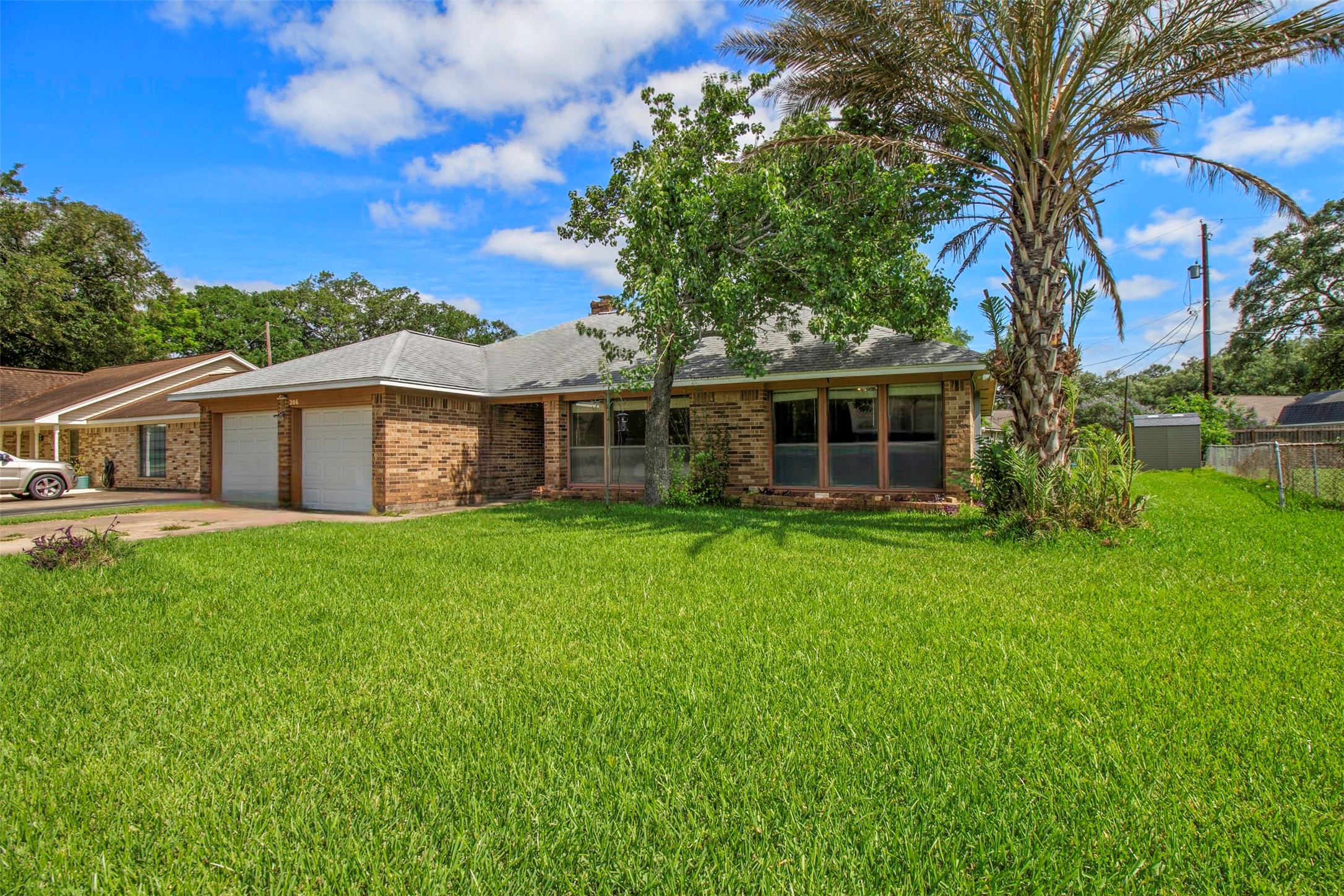 206 Stanford Road Lake Jackson, TX 77566 - Photo 3 of 26 a view of a house with backyard and garden