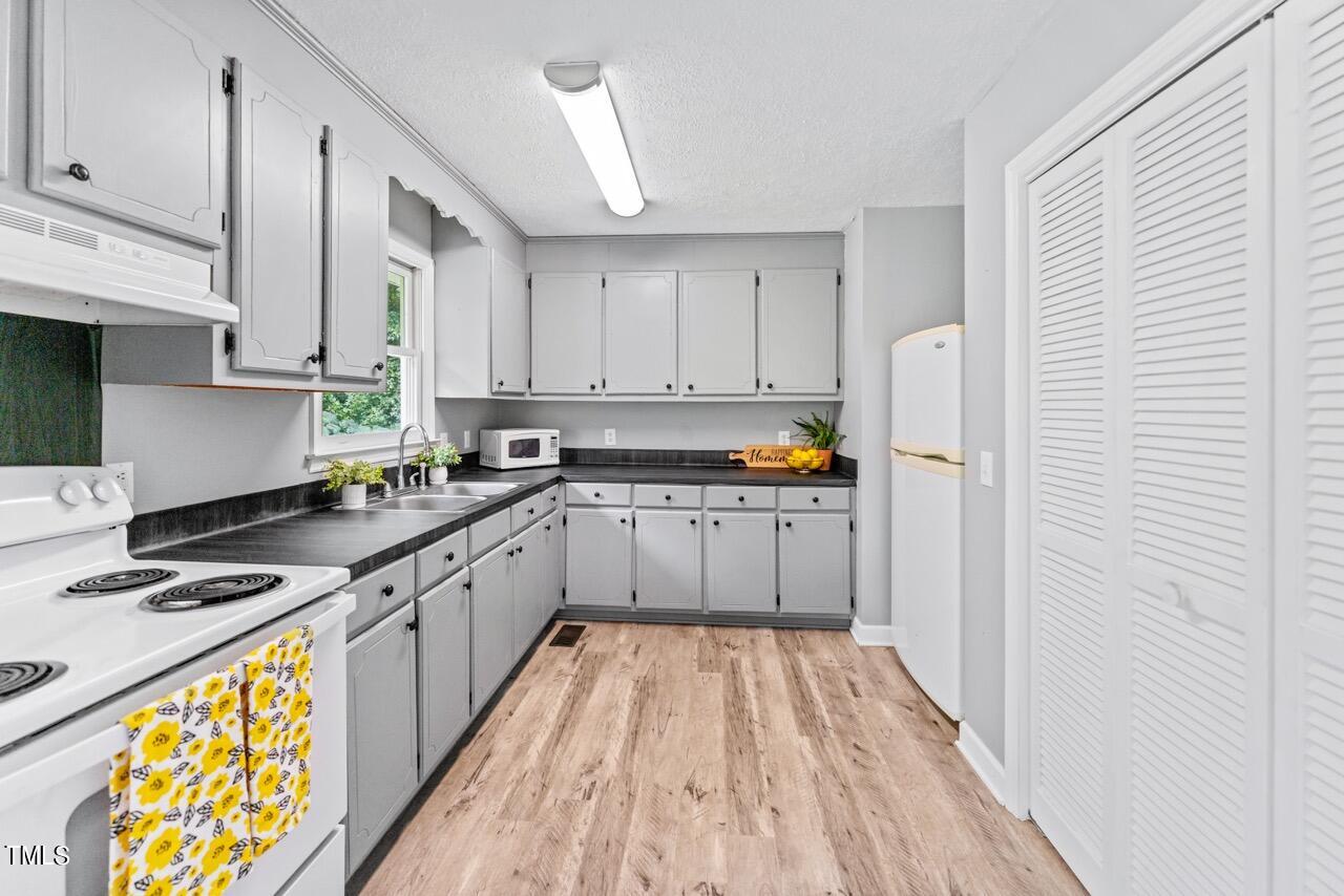 405 Marvin Gill Road Roxboro, NC 27574 - Photo 8 of 33 Kitchen with Laundry Closet