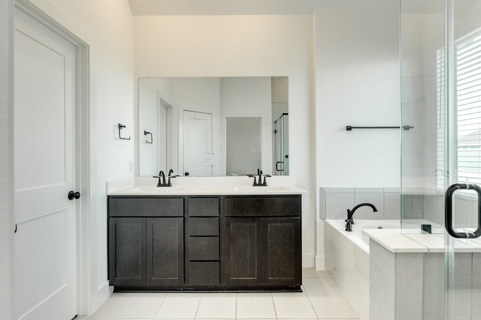 10002 Nectar Path Rosharon, TX 77583 - Photo 20 of 46 Primary bath features double vanities with quartz countertops, a soaking tub, and a glass walk-in shower.
