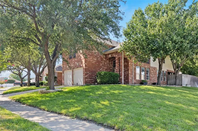 a front view of a house with a yard and fountain