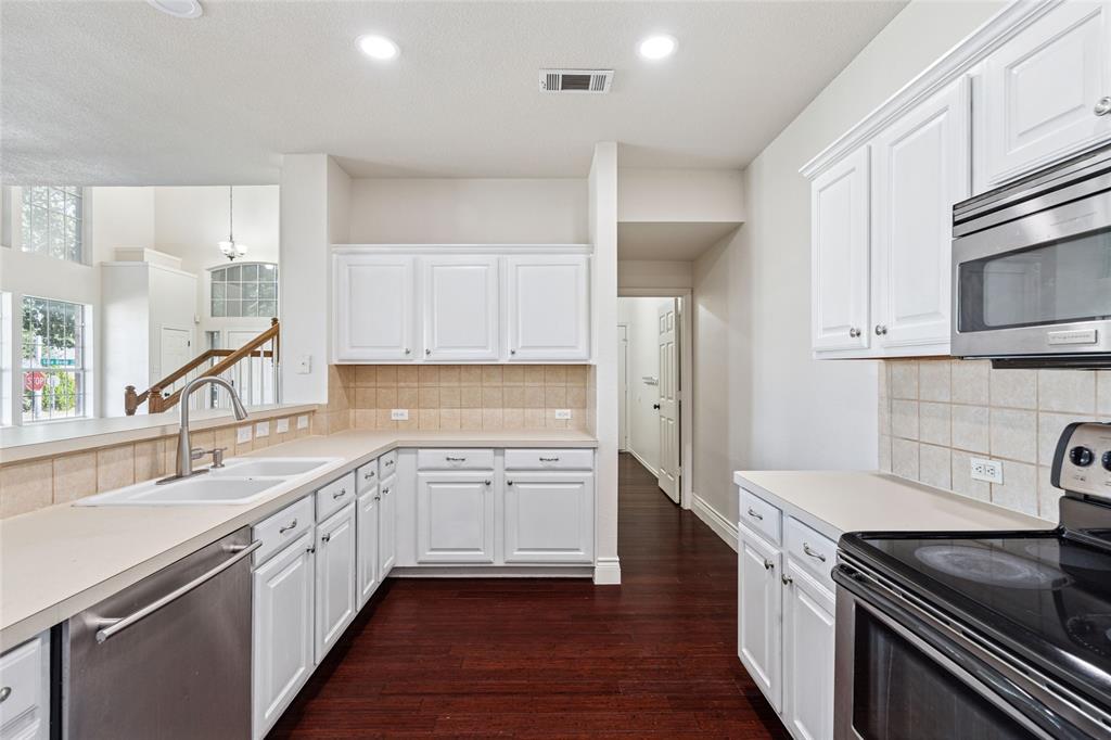 4509 Gila Bend Lane Fort Worth, TX 76137 - Photo 13 of 28 a kitchen with a sink stove top oven and cabinets