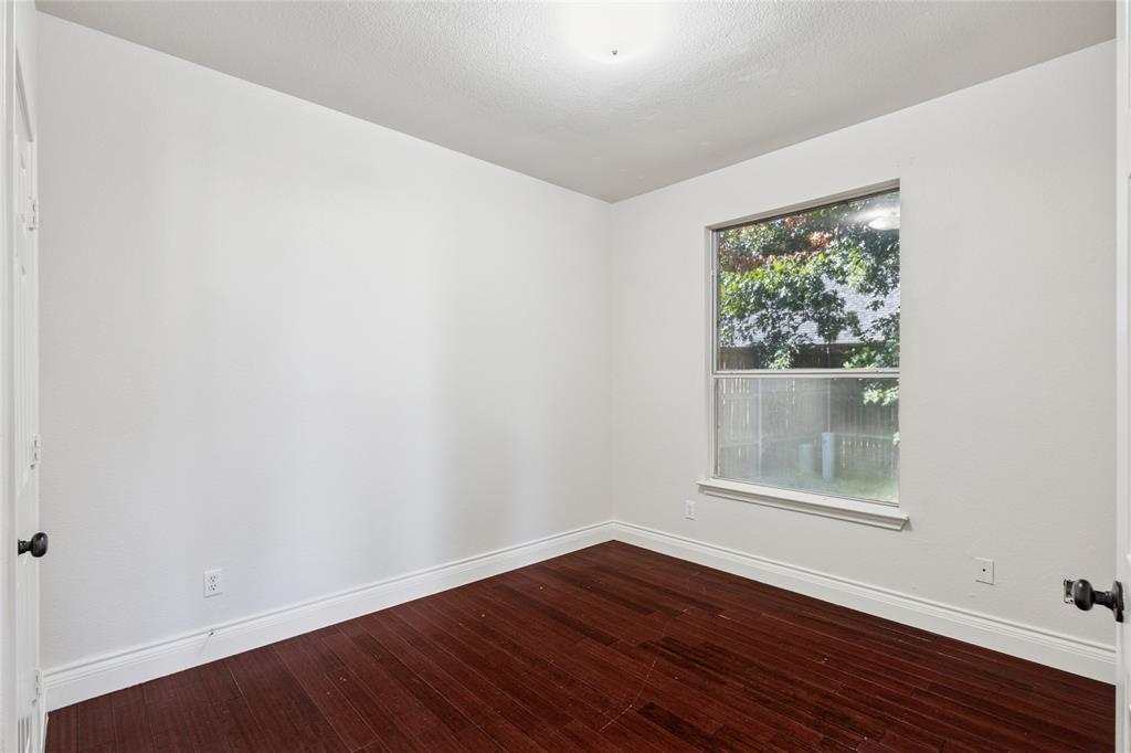 4509 Gila Bend Lane Fort Worth, TX 76137 - Photo 14 of 28 a view of an empty room with wooden floor and a window