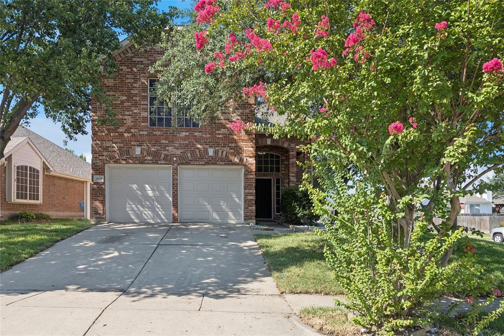 4509 Gila Bend Lane Fort Worth, TX 76137 - Photo 2 of 28 a front view of a house with a yard and fountain