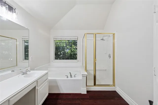 a bathroom with a double vanity sink a mirror and shower