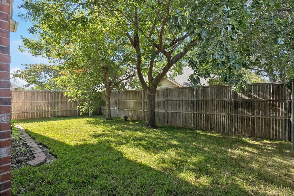 4509 Gila Bend Lane Fort Worth, TX 76137 - Photo 27 of 28 a backyard of a house with lots of green space