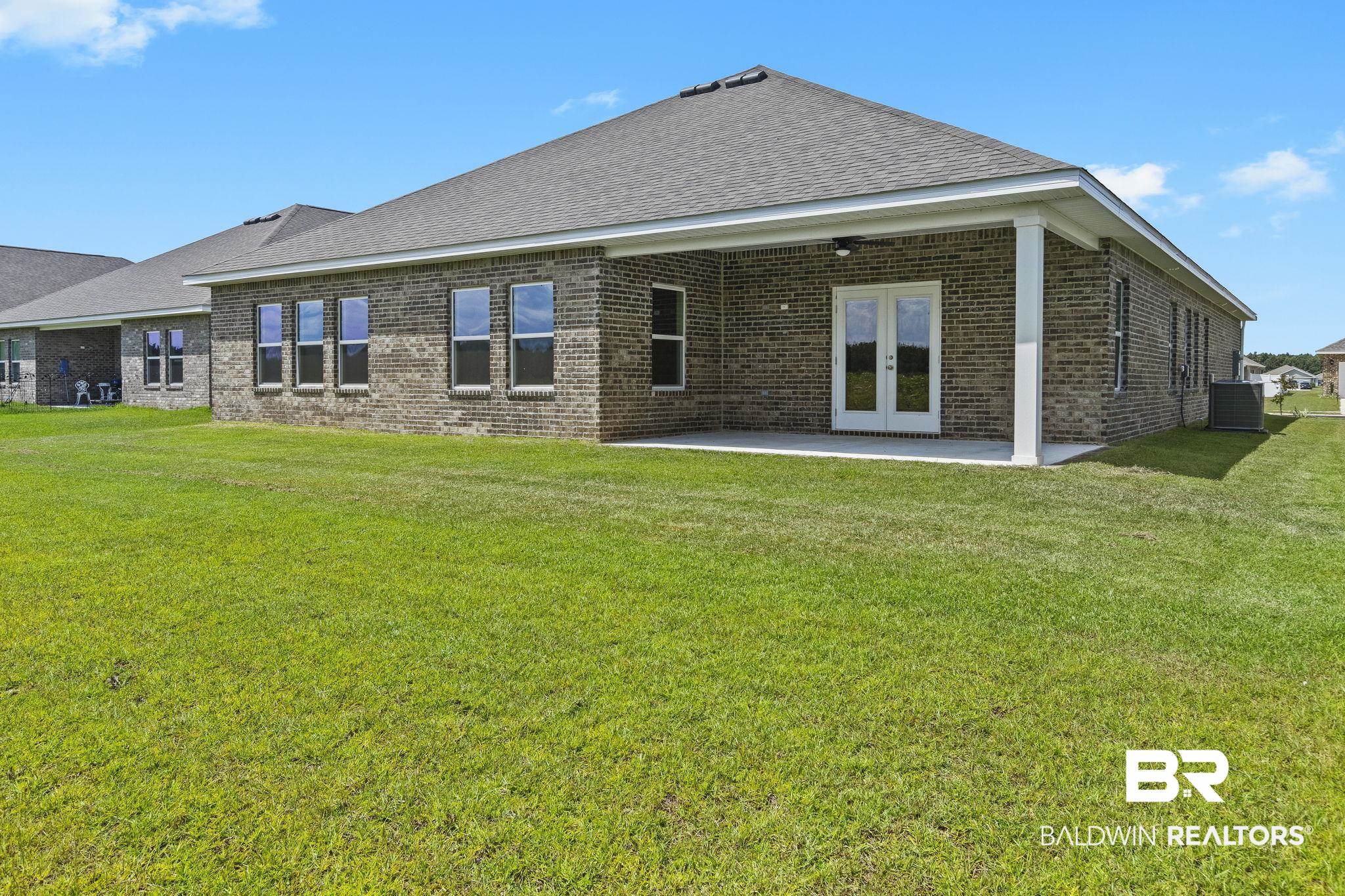 11303 Genuine Risk Circle Daphne, AL 36526 - Photo 69 of 100 Rear view of house featuring a lawn, french doors, and a patio area