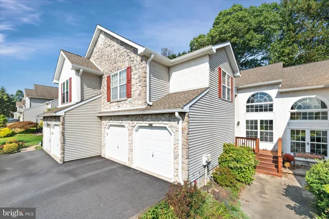 a view of a house with a yard and plants