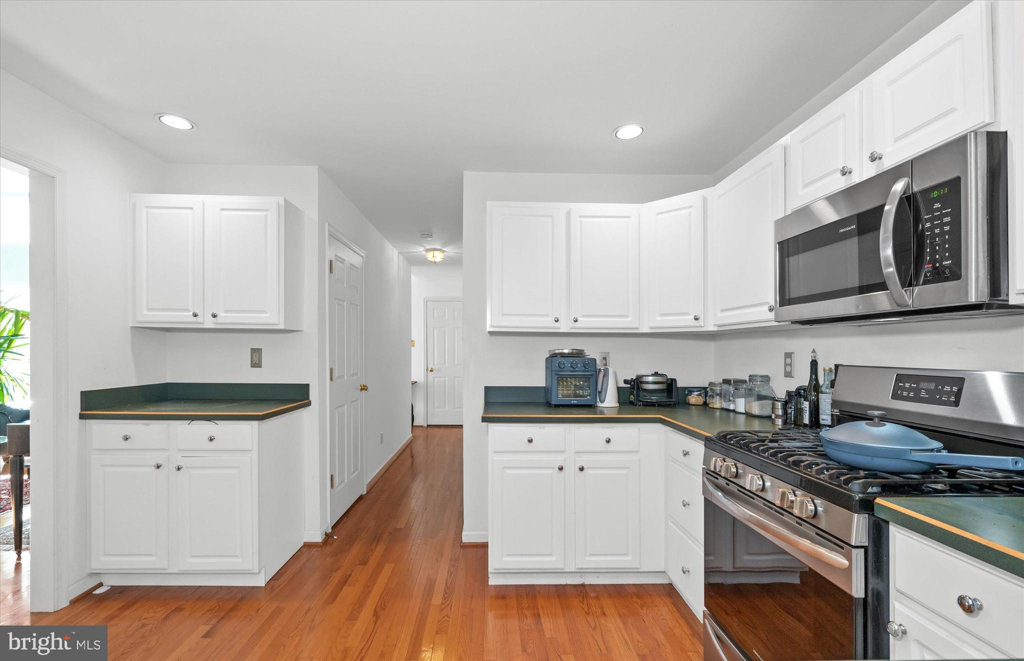 1015 Adams Way West Chester, PA 19382 - Photo 23 of 48 a kitchen with granite countertop a sink a stove and wooden cabinets