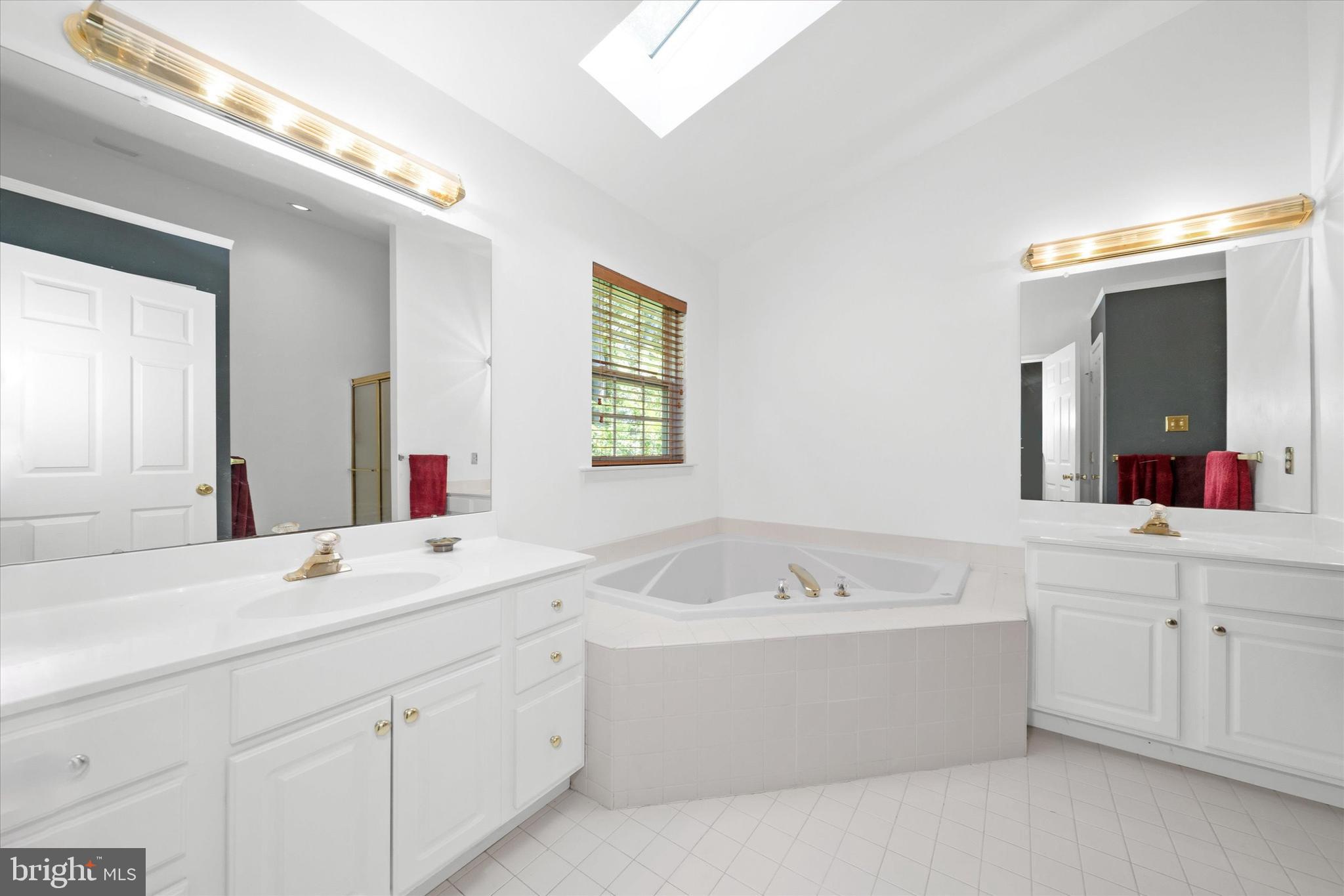 1015 Adams Way West Chester, PA 19382 - Photo 29 of 48 a bathroom with a double vanity sink mirror and bathtub