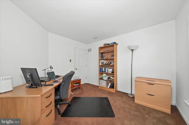 a room with furniture a air conditioner and a window