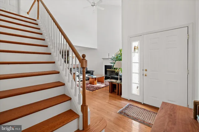 a view of entryway and hall with wooden floor