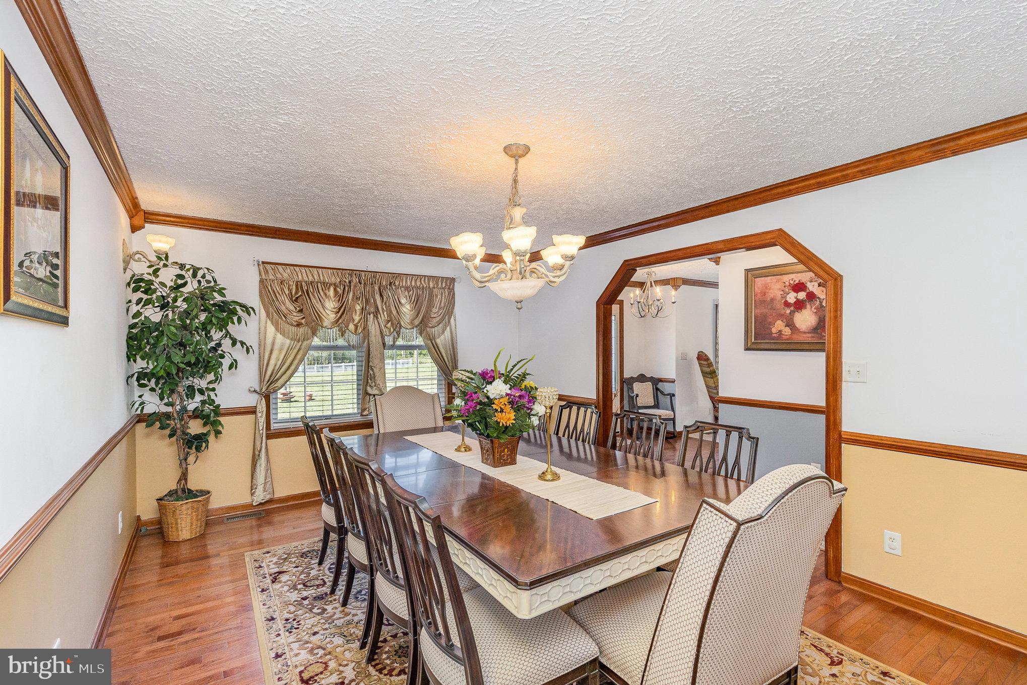 9121 Will Loop King George, VA 22485 - Photo 12 of 52 a view of a dining room with furniture a chandelier and wooden floor
