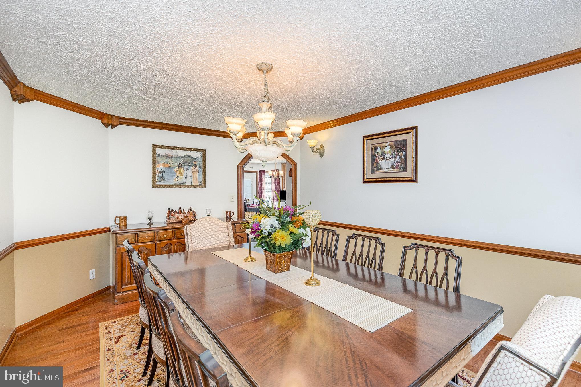 9121 Will Loop King George, VA 22485 - Photo 13 of 52 a view of a dining room with furniture a chandelier and wooden floor