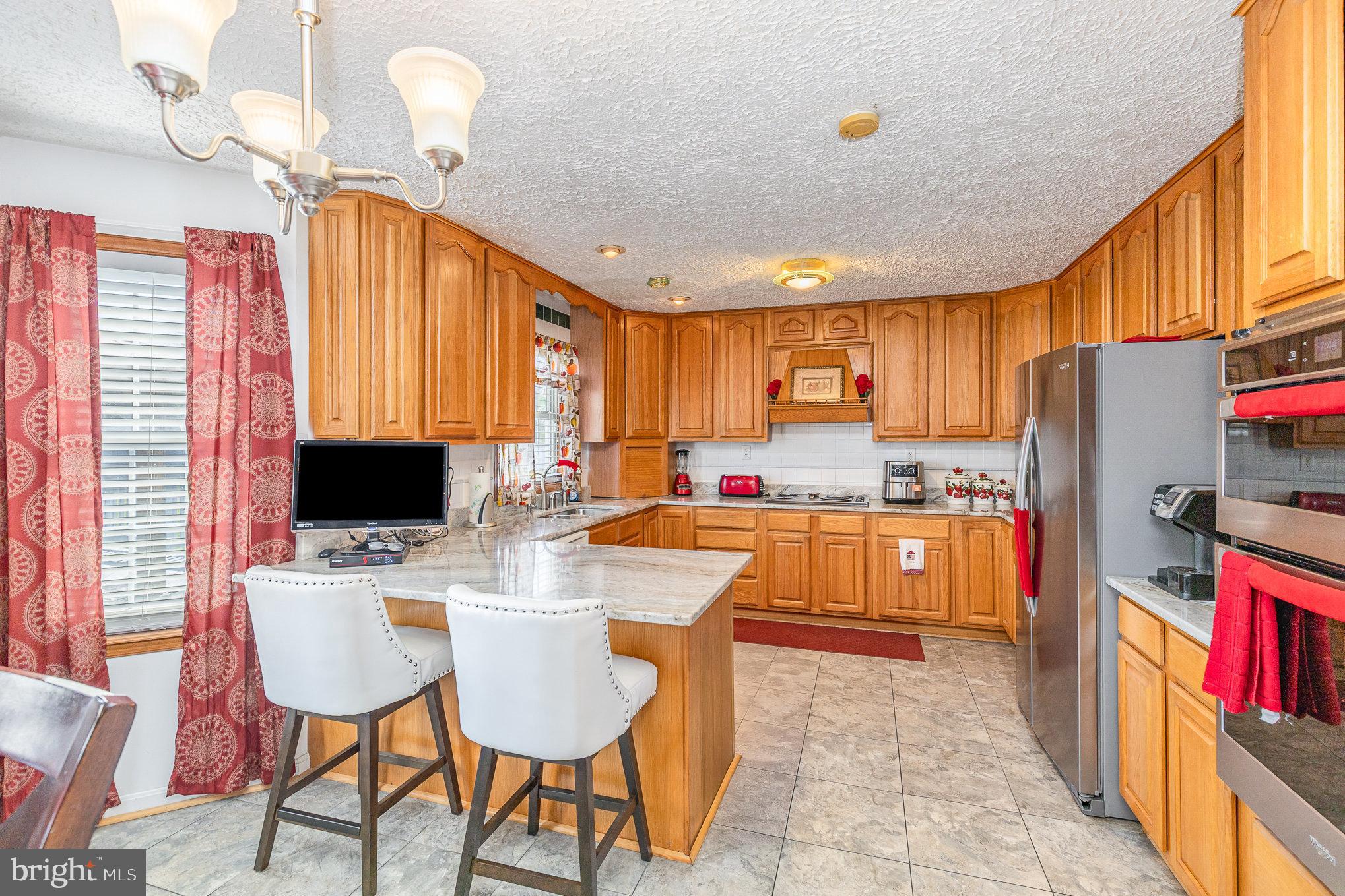 9121 Will Loop King George, VA 22485 - Photo 15 of 52 a large kitchen with a table chairs refrigerator and a window