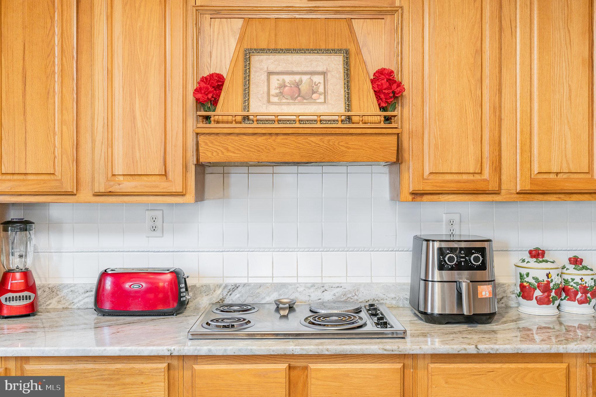 9121 Will Loop King George, VA 22485 - Photo 18 of 52 a kitchen with kitchen island a sink and wooden floor