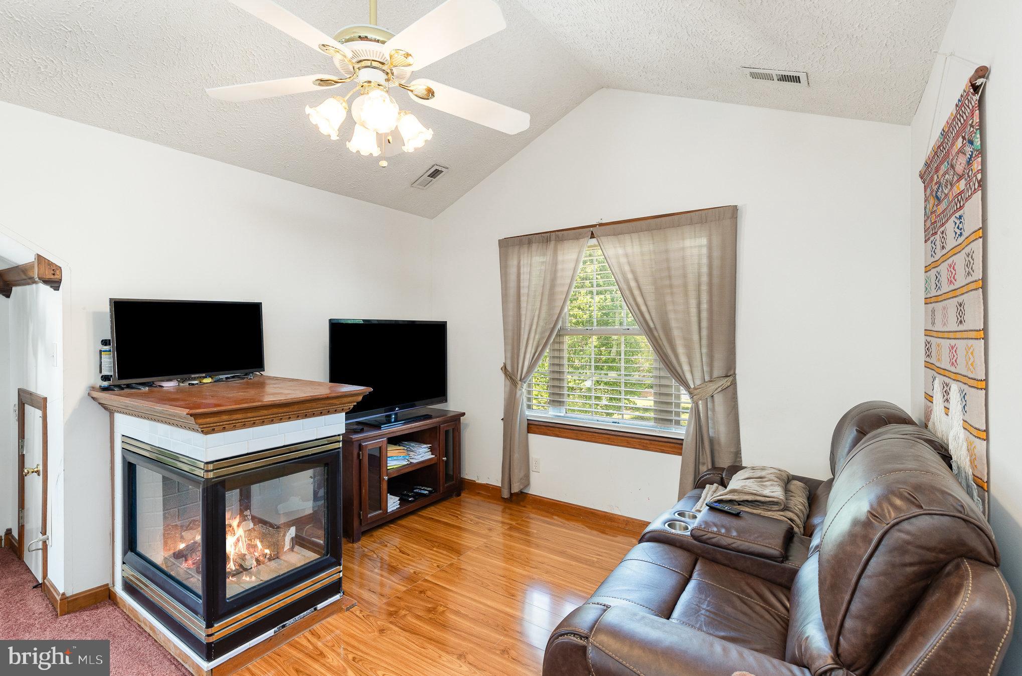 9121 Will Loop King George, VA 22485 - Photo 22 of 52 a living room with furniture and a flat screen tv