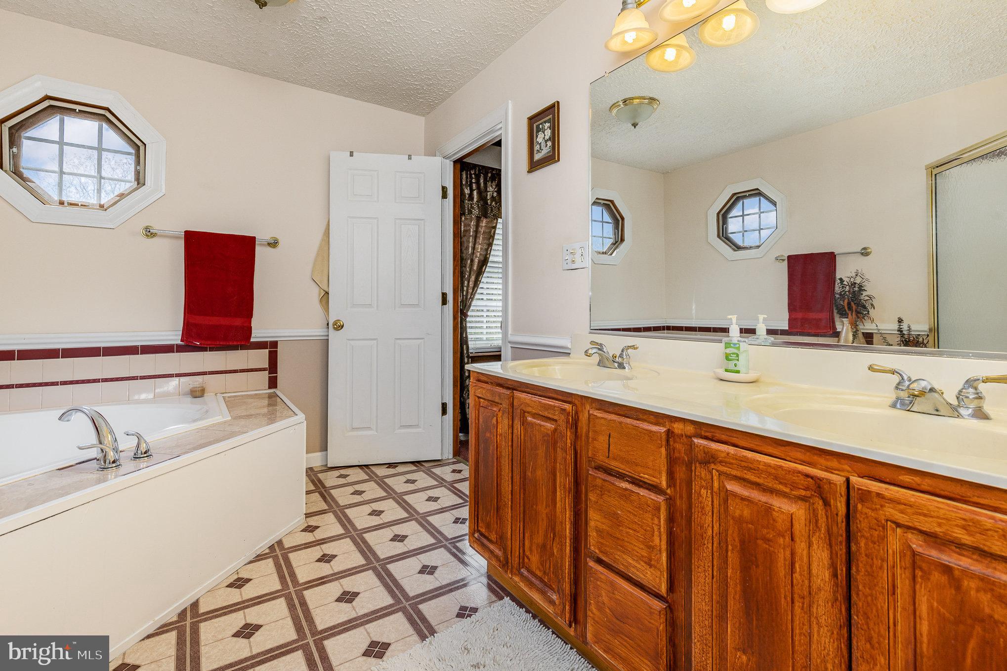 9121 Will Loop King George, VA 22485 - Photo 25 of 52 a bathroom with a sink double vanity and a mirror