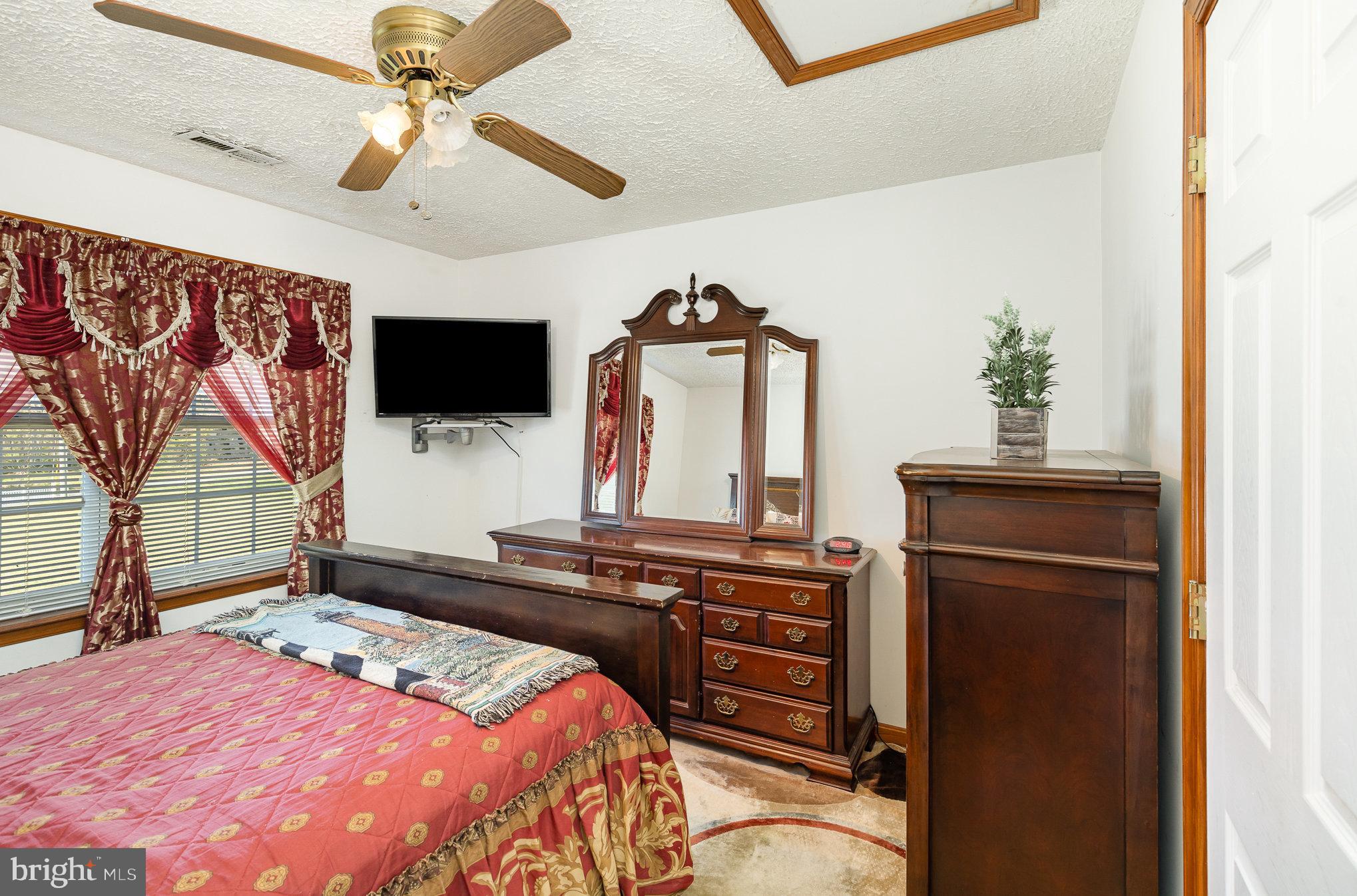 9121 Will Loop King George, VA 22485 - Photo 27 of 52 a bedroom with a bed and a flat screen tv