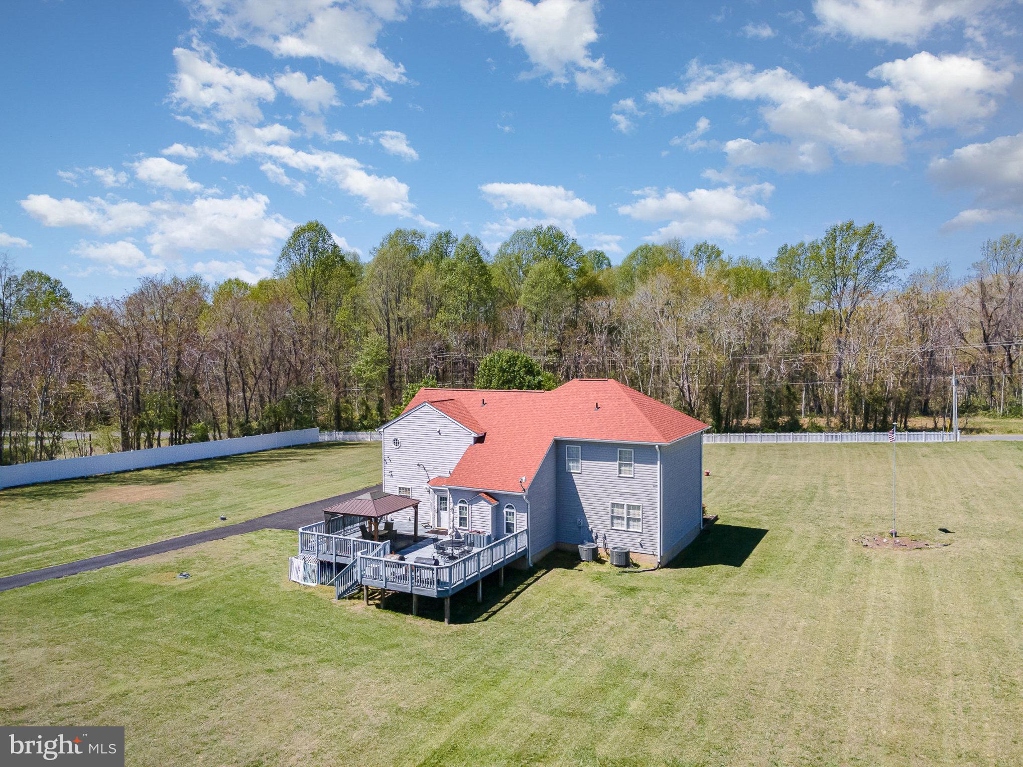 9121 Will Loop King George, VA 22485 - Photo 40 of 52 a view of a houses with swimming pool and trees in the background