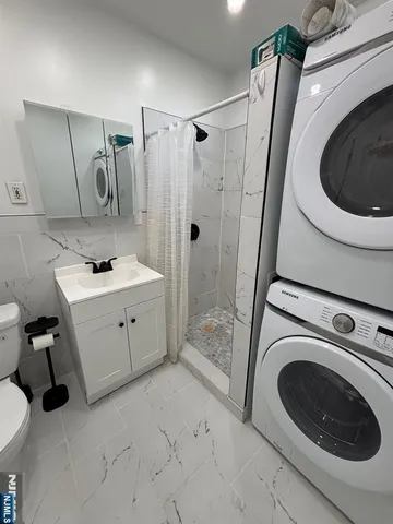 a utility room with sink dryer and washer