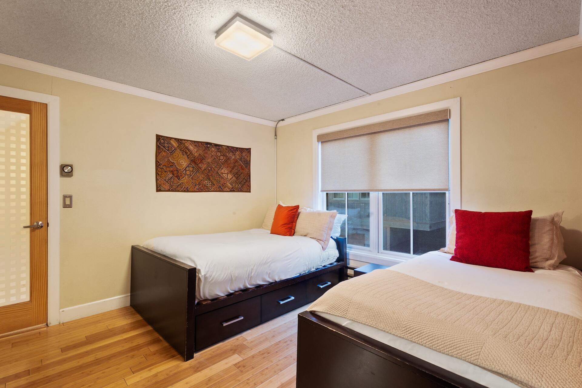 260 South Aspen Street, Unit D 2 Telluride, CO 81435 - Photo 19 of 30 a bedroom with two beds and a night stand