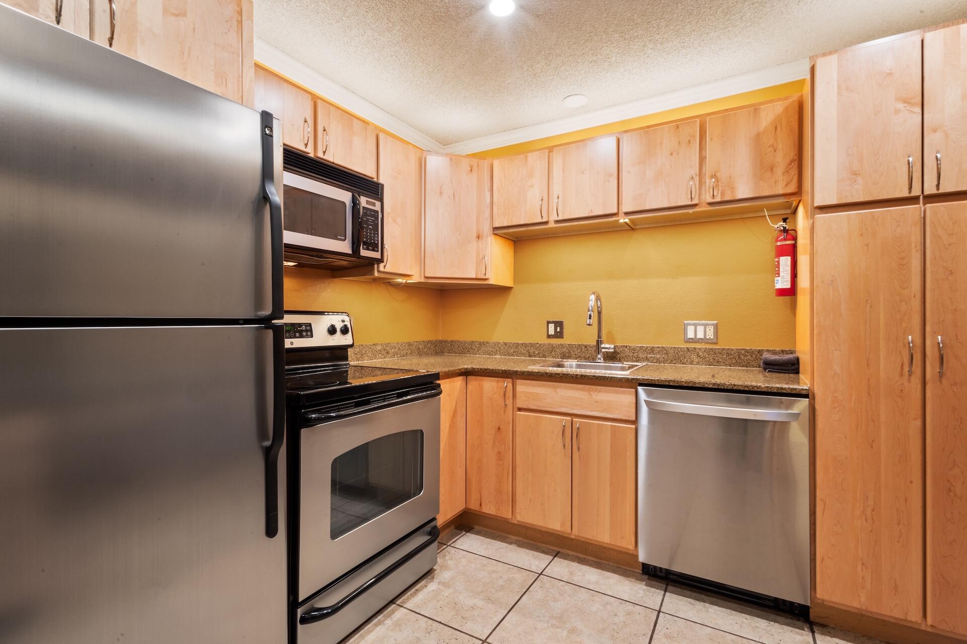 260 South Aspen Street, Unit D 2 Telluride, CO 81435 - Photo 8 of 30 a kitchen with stainless steel appliances granite countertop a refrigerator a sink and white cabinets