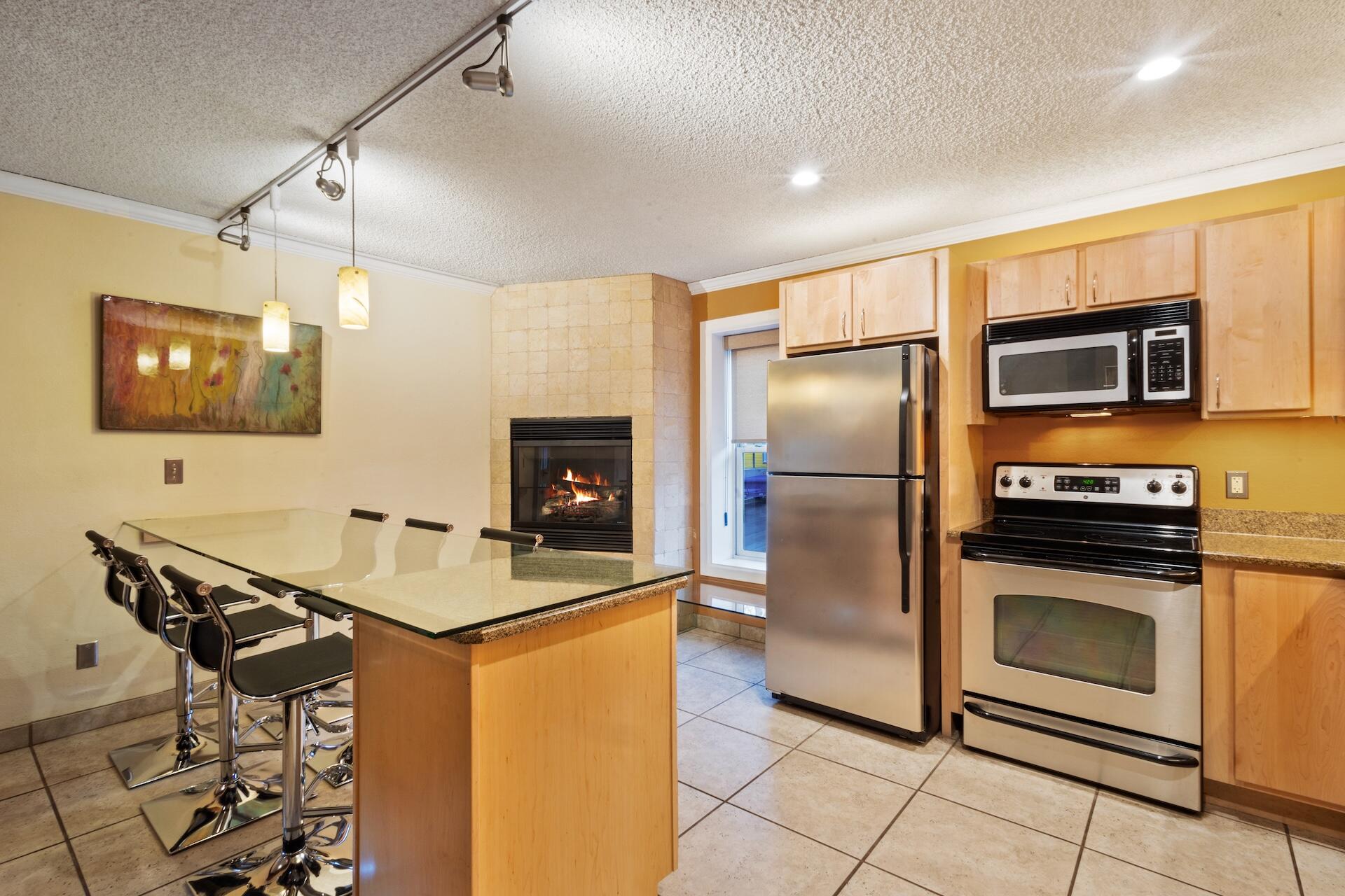 260 South Aspen Street, Unit D 2 Telluride, CO 81435 - Photo 9 of 30 a kitchen with kitchen island a counter top space appliances and cabinets