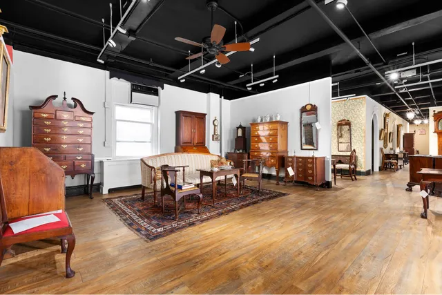 a view of a room with wooden floor table and chairs