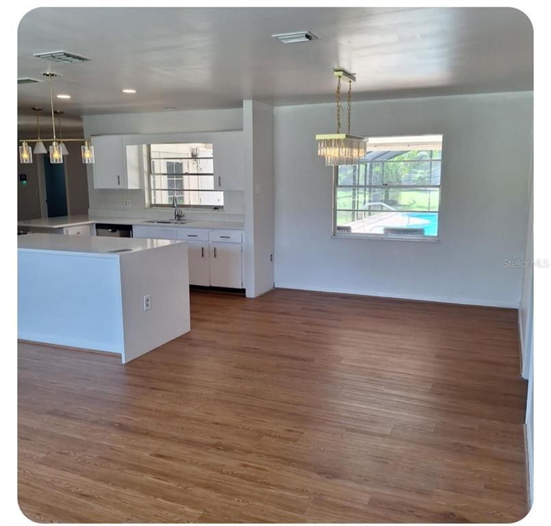 514 Spring Oaks Boulevard Altamonte Springs, FL 32714 - Photo 3 of 16 a kitchen with stainless steel appliances wooden floor and a refrigerator