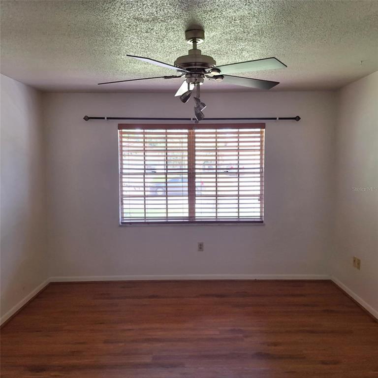 514 Spring Oaks Boulevard Altamonte Springs, FL 32714 - Photo 6 of 16 a view of empty room with wooden floor and fan