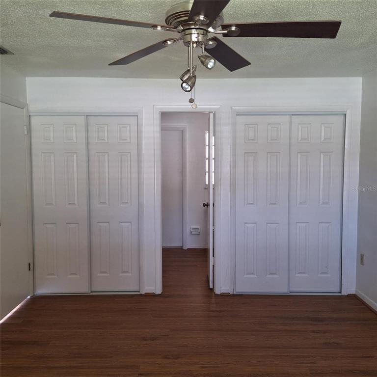 514 Spring Oaks Boulevard Altamonte Springs, FL 32714 - Photo 7 of 16 a view of hallway with wooden floor and ceiling fan