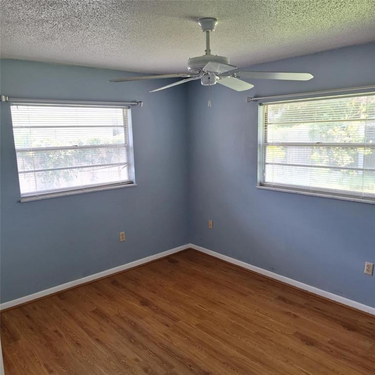 514 Spring Oaks Boulevard Altamonte Springs, FL 32714 - Photo 10 of 16 a view of an empty room with wooden floor and a window