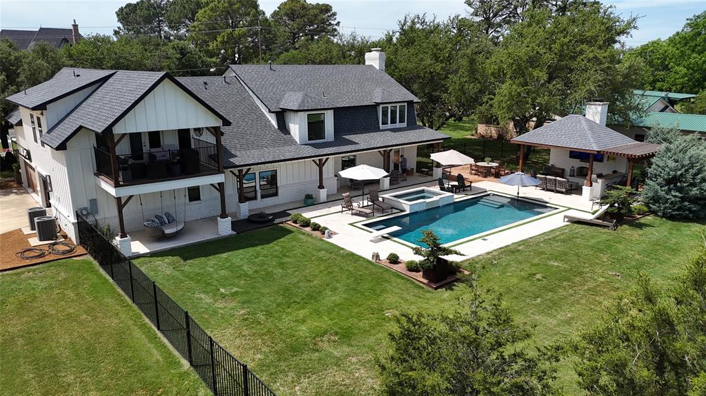 1304 Tinker Road Colleyville, TX 76034 - Photo 24 of 28 a aerial view of a house with swimming pool and a yard
