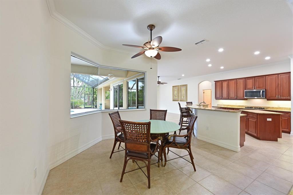 10622 Conch Shell Terrace Bradenton, FL 34212 - Photo 29 of 69 a kitchen with a table chairs and microwave