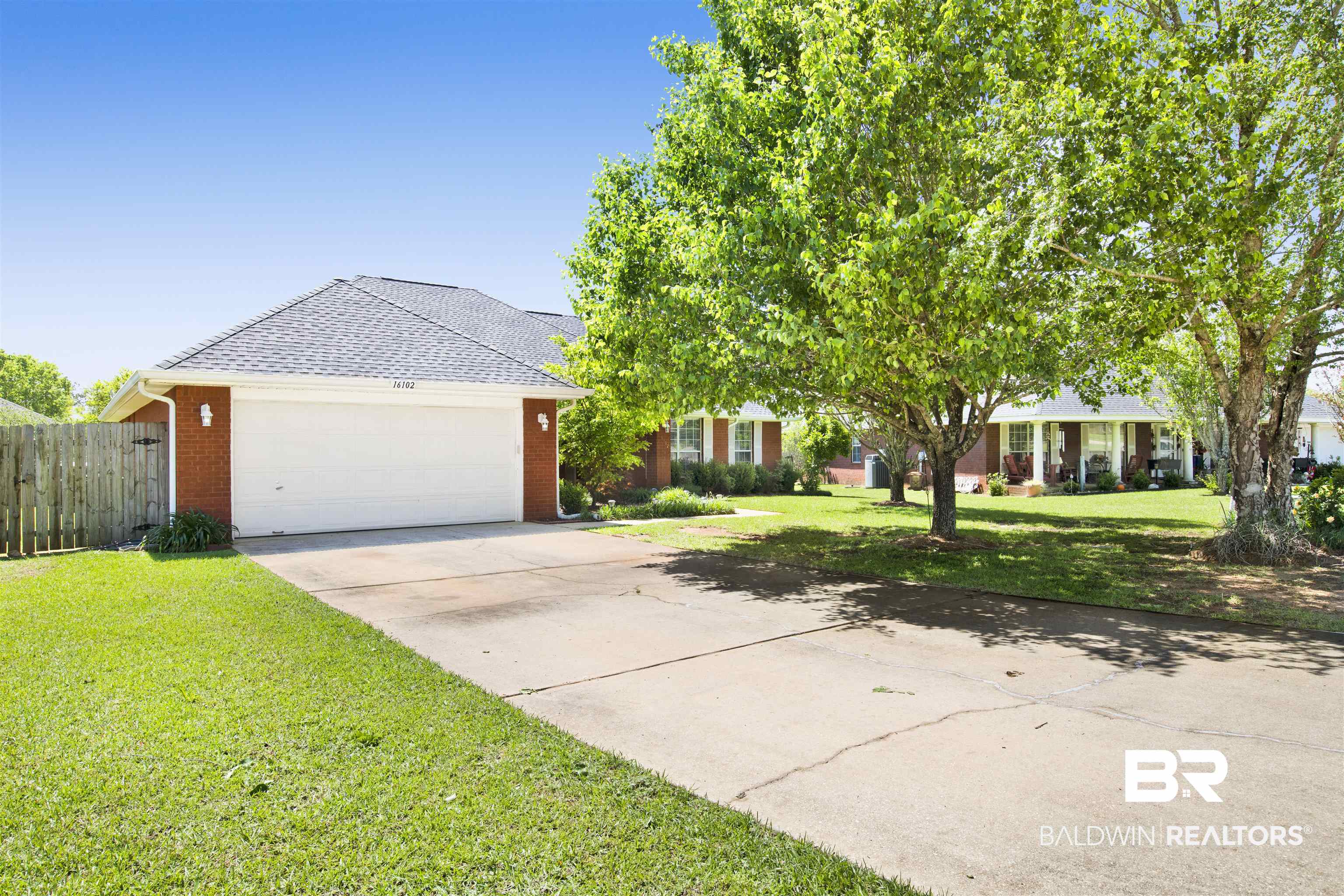 16102 Masada Court Loxley, AL 36551 - Photo 4 of 35 View of front of house with brick siding, a front yard, roof with shingles, and concrete driveway
