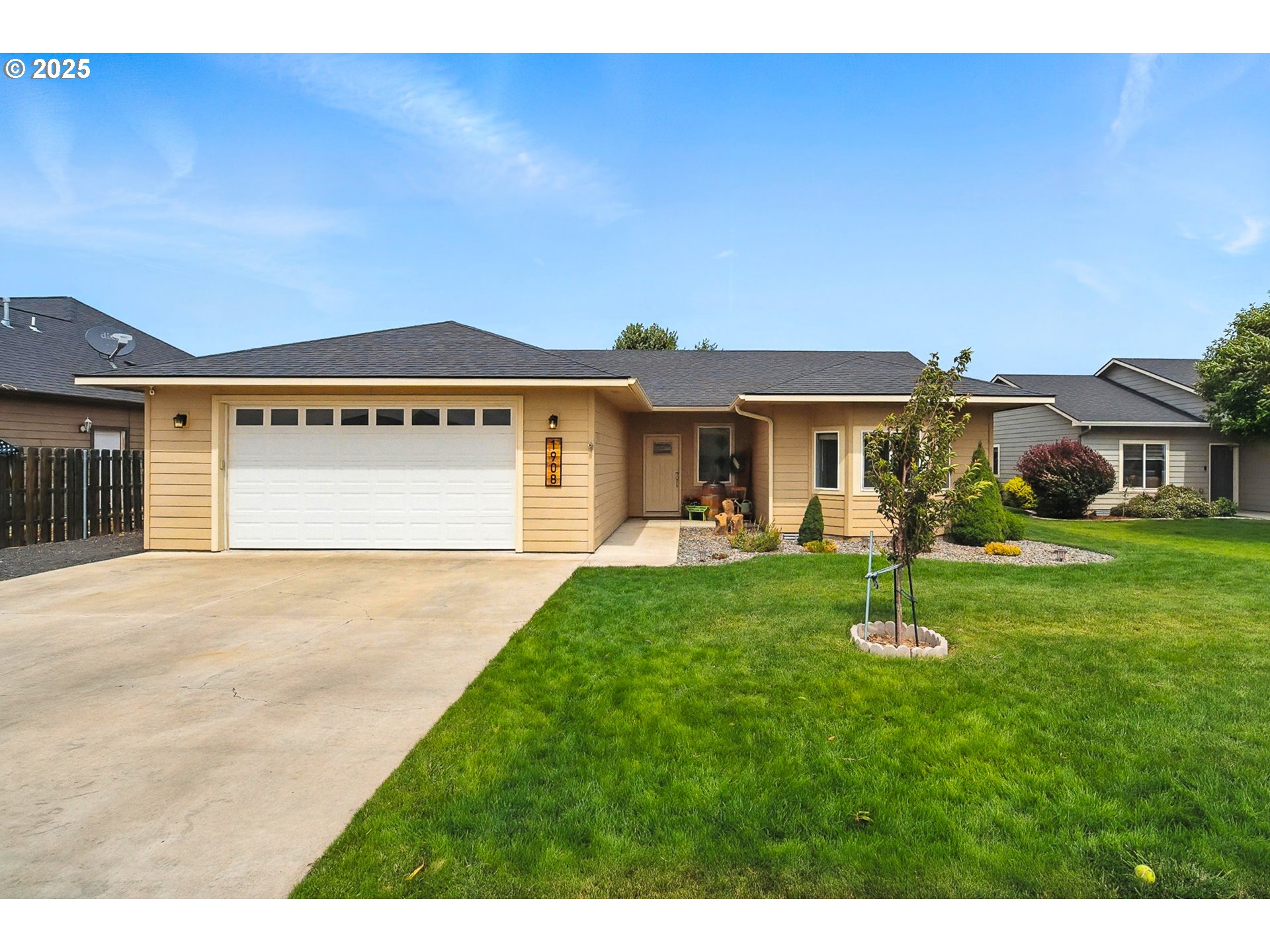 a front view of a house with a garden