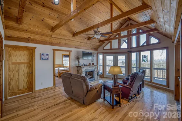 a living room with furniture fireplace and wooden floor