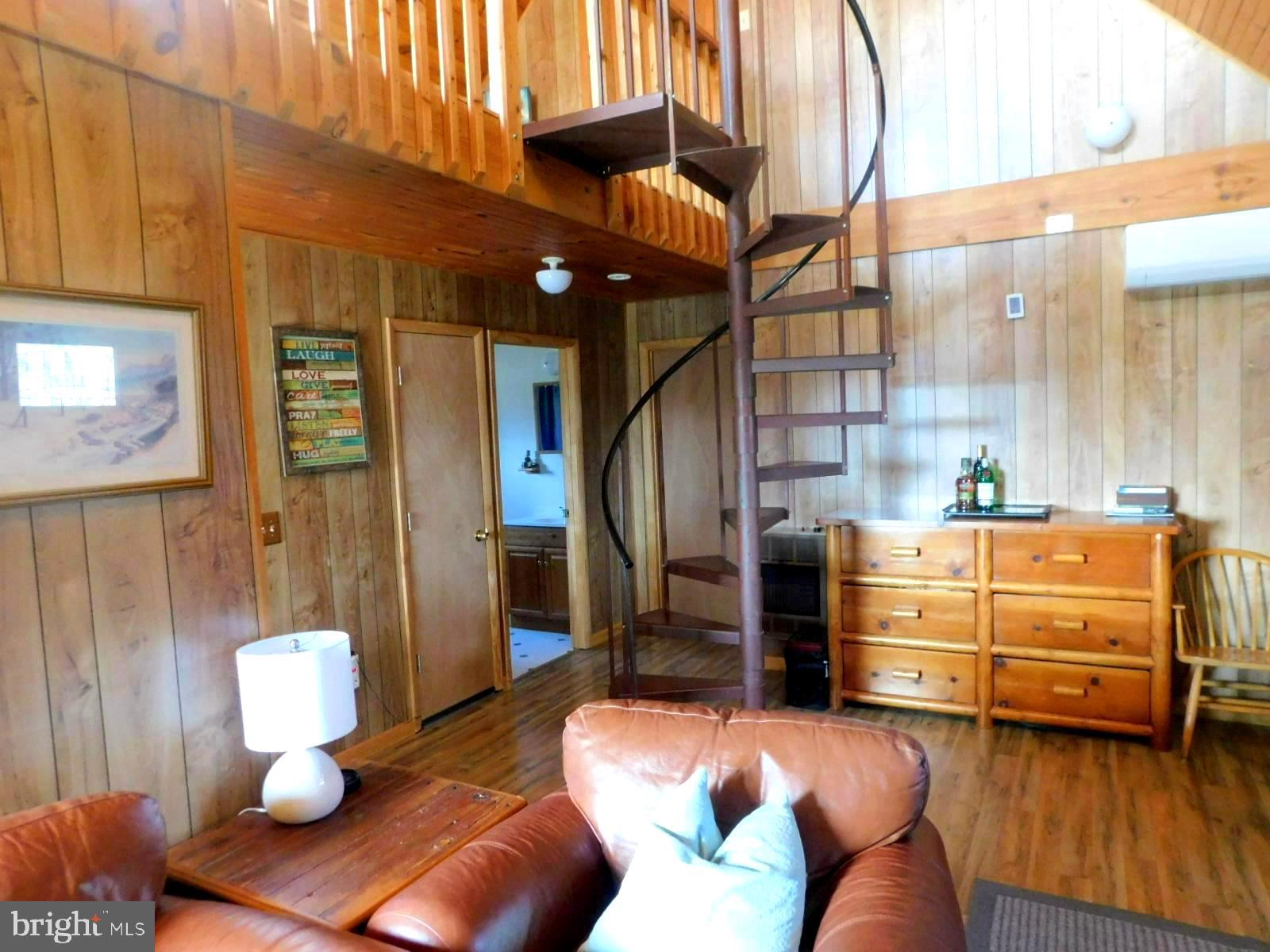 6751 High Knob Road Old Fields, WV 26845 - Photo 12 of 26 a living room with furniture and a chandelier