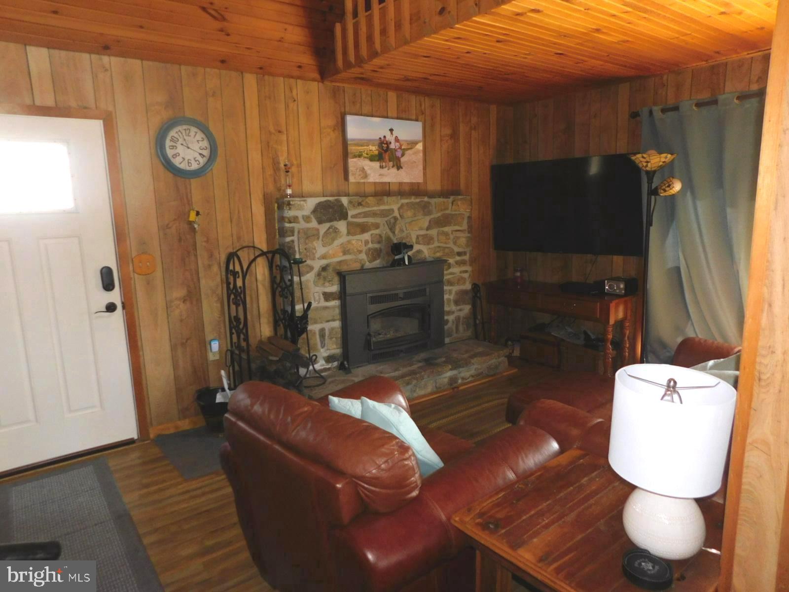 6751 High Knob Road Old Fields, WV 26845 - Photo 6 of 26 a living room with furniture and a fireplace
