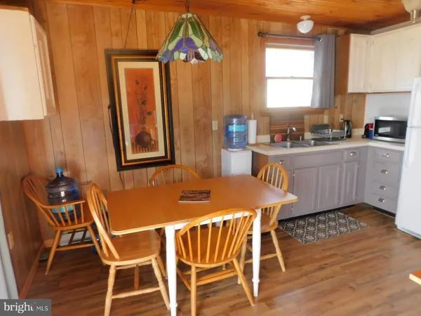 a kitchen with a table chairs and a refrigerator