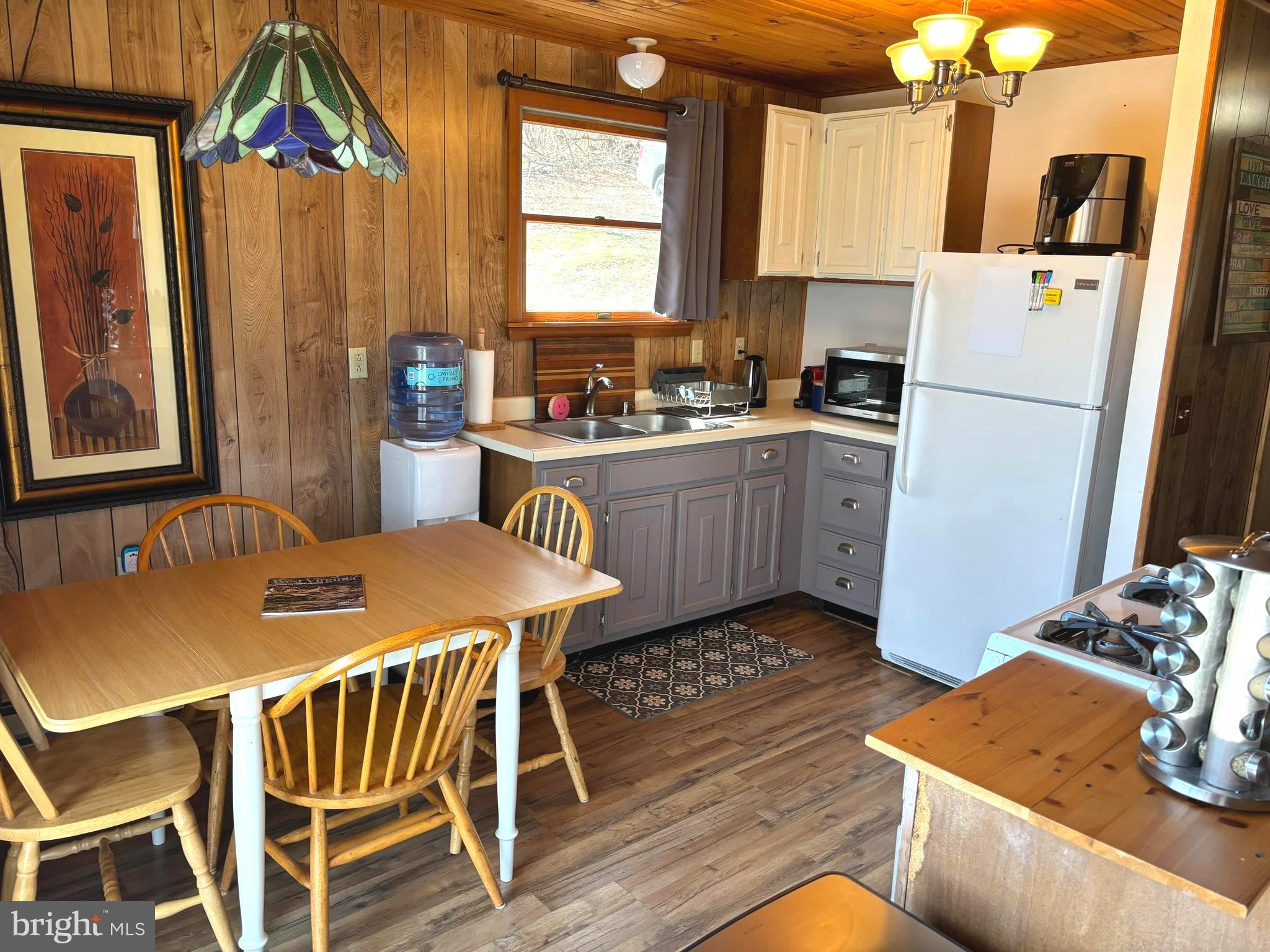 6751 High Knob Road Old Fields, WV 26845 - Photo 8 of 26 a kitchen with a table chairs and a refrigerator