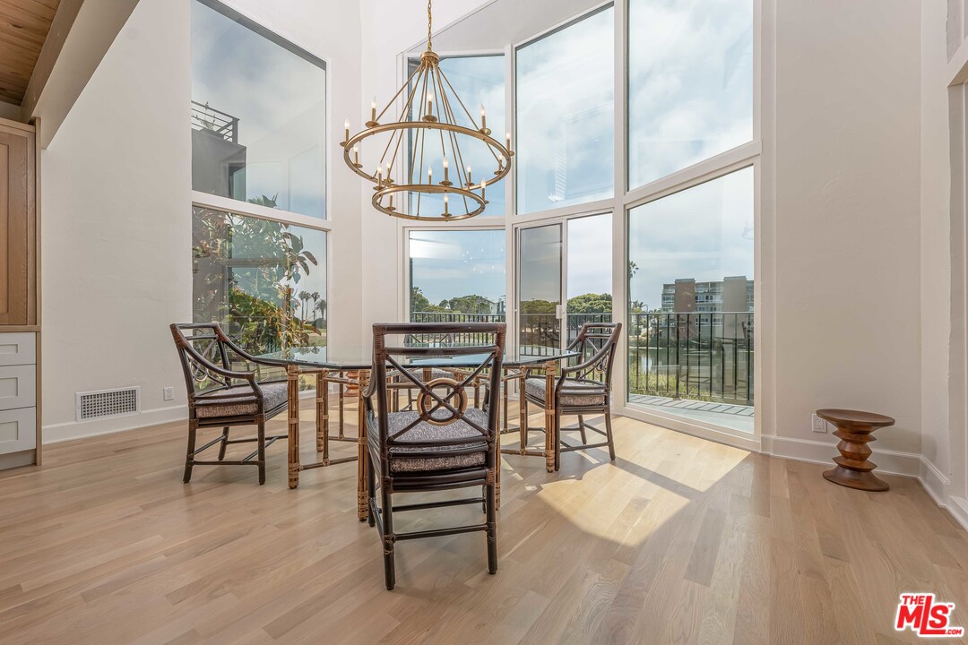 6501 Esplanade Playa del Rey, CA 90293 - Photo 15 of 54 a view of a dining room with furniture wooden floor and a chandelier