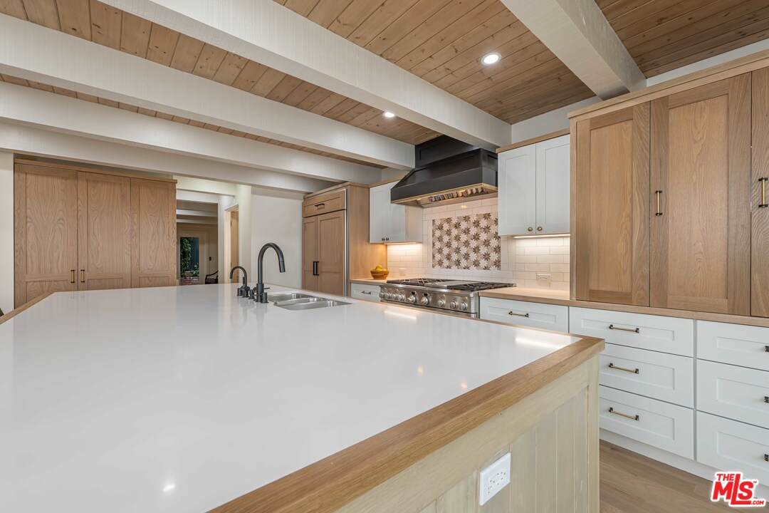 6501 Esplanade Playa del Rey, CA 90293 - Photo 19 of 54 a large white kitchen with kitchen island a sink stainless steel appliances and cabinets