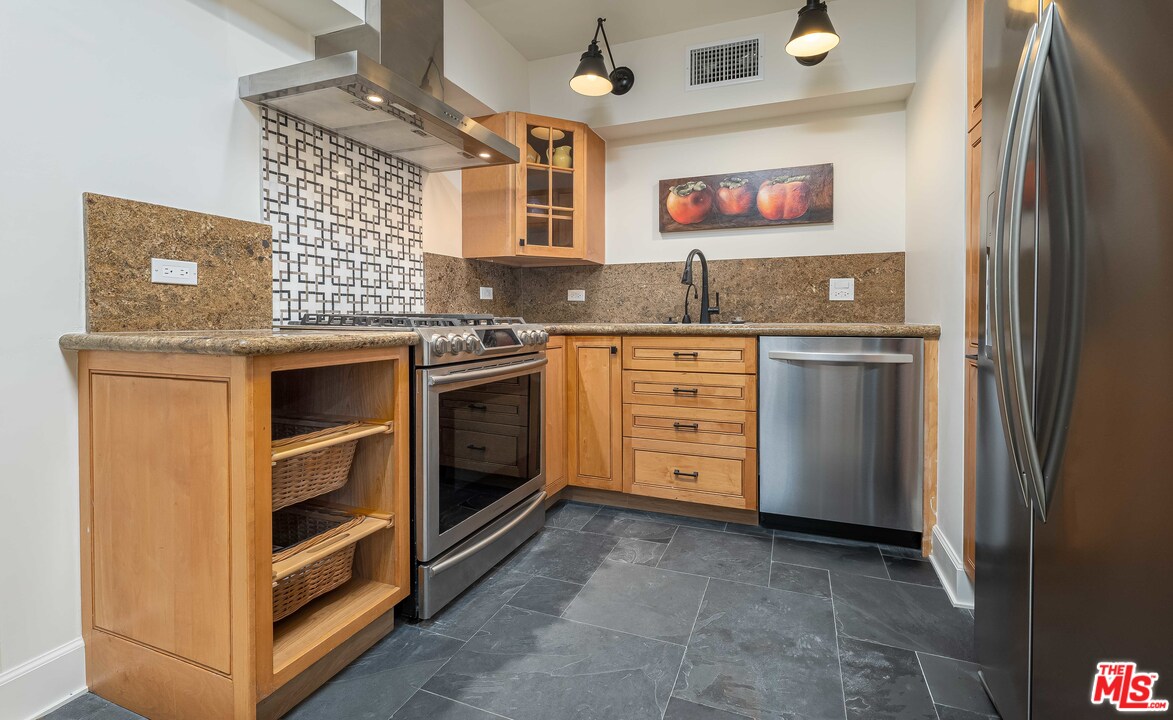 6501 Esplanade Playa del Rey, CA 90293 - Photo 42 of 54 a kitchen with stainless steel appliances granite countertop a stove and a refrigerator