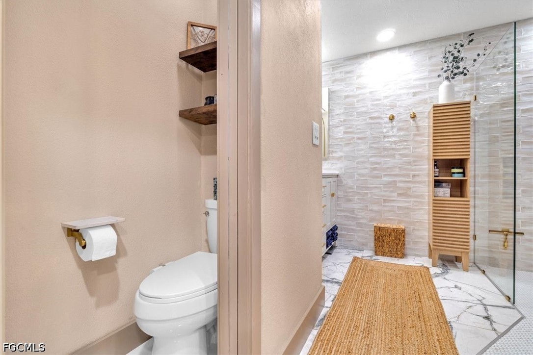 202 Ridgewood Avenue Clewiston, FL 33440 - Photo 47 of 50 a bathroom with a toilet and a shower