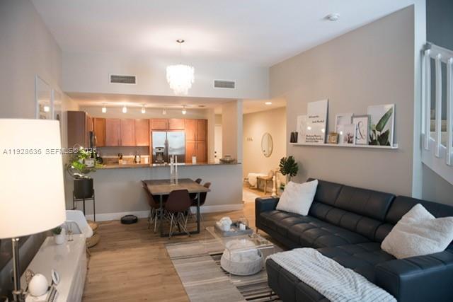 8395 Southwest 73rd Avenue, Unit 105 Miami, FL 33143 - Photo 14 of 14 a living room with furniture a rug and kitchen view