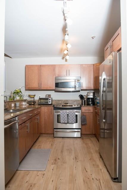 8395 Southwest 73rd Avenue, Unit 105 Miami, FL 33143 - Photo 4 of 14 a kitchen with stainless steel appliances granite countertop a refrigerator a stove and a sink