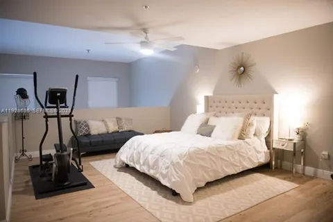 a bedroom with a bed and a mirror